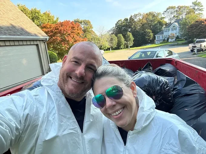 Pest inspector examining home exterior for signs of infestation