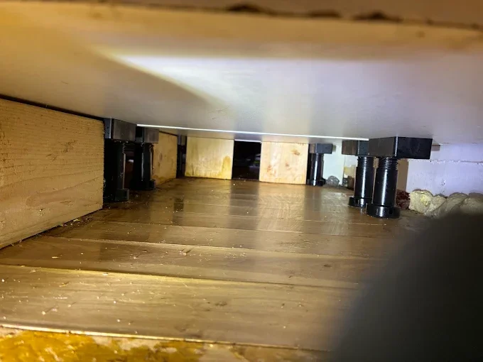 Crawl space pest control treatment with wooden beams and foundation area