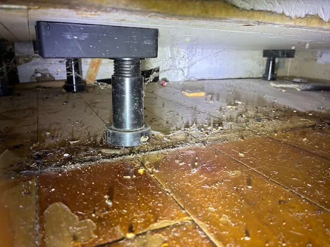 Crawl space treatment with adjustable support post and pest control application on soil