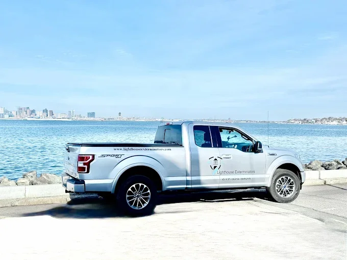 White Ford F-150 service truck with professional pest control company branding and graphics