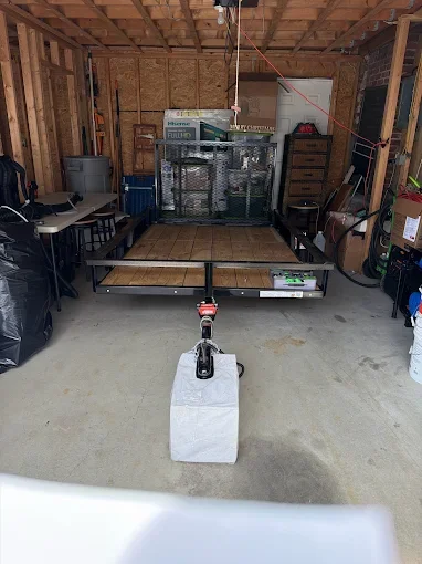 Garage interior with concrete floor, wooden frame structure, and treatment equipment setup